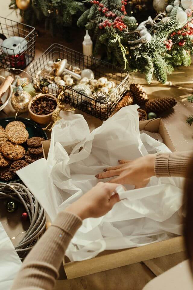 Hands tying a gift with fine silk ribbon